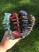 Load image into Gallery viewer, 4 different hand-made crystal tiaras with grass in the background
